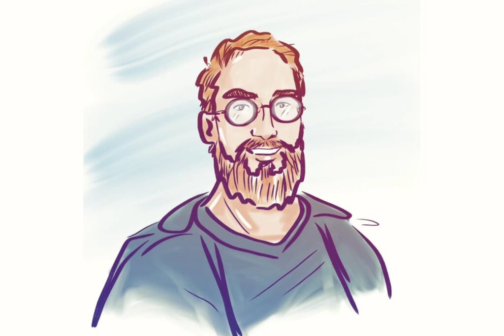 Ein vollbärtiger Mann mit Brille.